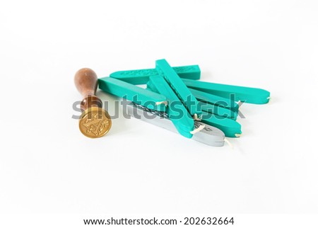 turquoise and silver sealing wax candles with stamp isolated on white background with shadow