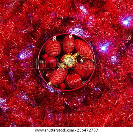 red and yellow vintage christmas baubles on sparkling red and blue LED background, selective focus
