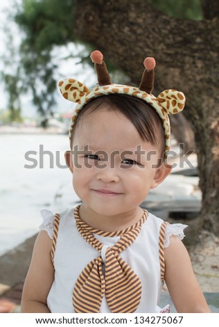 Cute asian girl with hair band portrait.