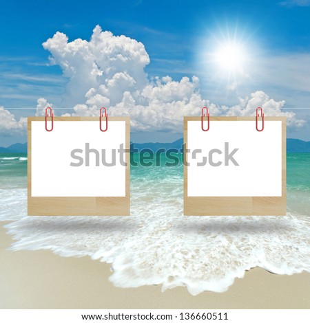 two hanging signs over seascape background.
