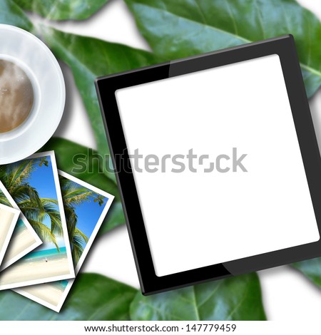 Blank touch screen computer on seamless green leaves background.