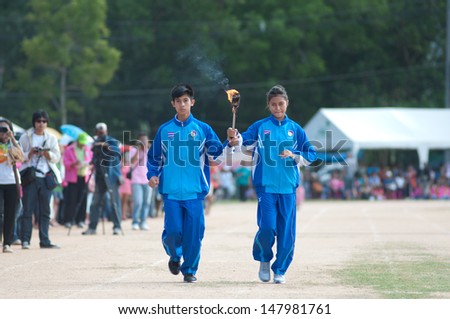 KO SAMUI,SURAT THANI - JULY 18 : Unidentified Thai students 4 - 7 years old with light torch in ceremony uniform during sport parade on July 18, 2012 in ko samui, Surat Thani, Thailand.