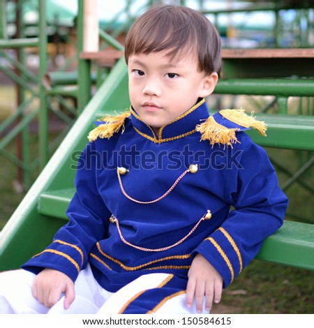 Cute asian six years old boy in bright blue shirt portrait.