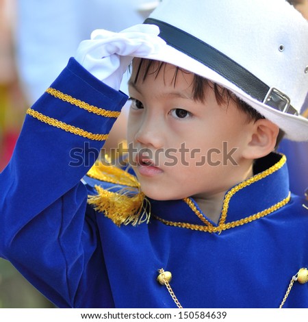 Cute asian six years old boy in bright blue shirt portrait.