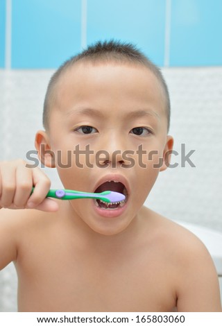 Cute asian boy brush the teeth.