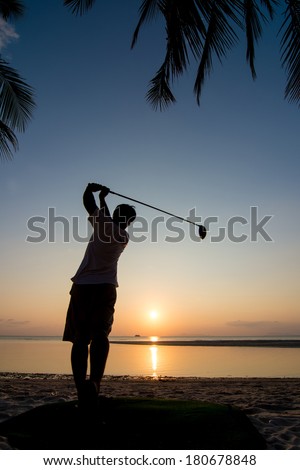 silhouette of golf player action at sunset.