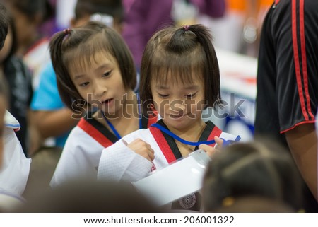 SURTTHANI, THAILAND - JULY 12: Unidentified Thai students 4 - 17 years old in action at suratthani taekwondo championship 2014 on July 12, 2014 in Suratthani, Thailand.
