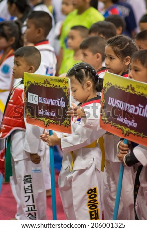 SURTTHANI, THAILAND - JULY 12: Unidentified Thai students 4 - 17 years old in action at suratthani taekwondo championship 2014 on July 12, 2014 in Suratthani, Thailand.