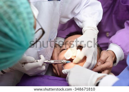 Young asian boy during dental extraction.