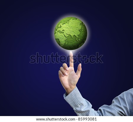 businessman hand pointing on green globe on attractive background.
