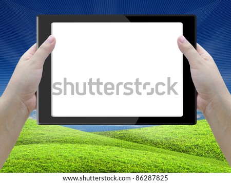 tablet computer with lady hand on nature background.
