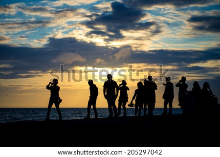 Silhouette group of people watching sunset at the coast sunset at the coast