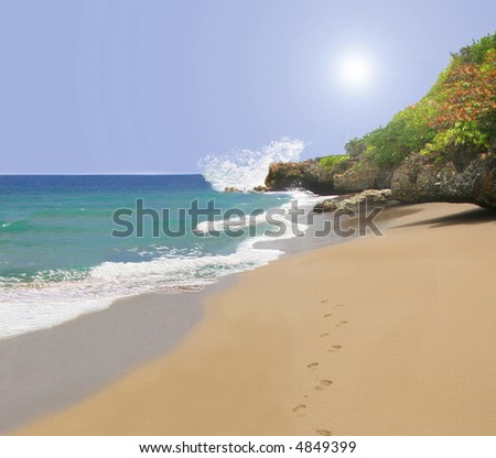 Beach with footprints in sand at water\'s edge with Spiritual glow in the sky,  horizontal