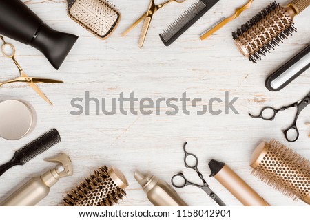 Various hair dresser tools on wooden background with copy space