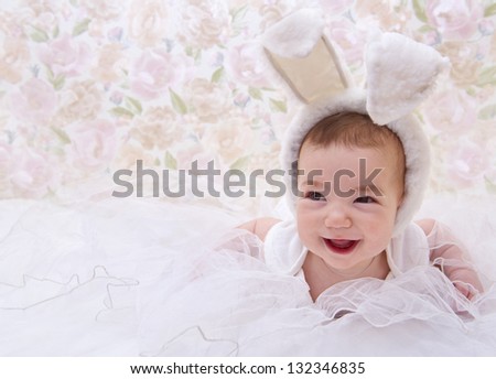 Smiling baby in rabbit costume