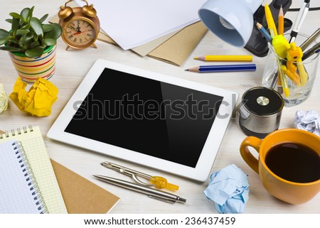 Tablet computer in a work mess on office desk