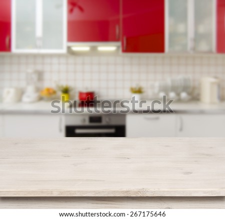 Wooden table on red modern kitchen bench interior background