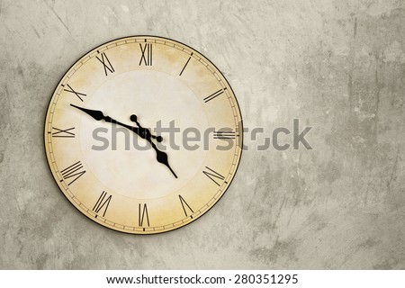 Vintage wall clock over grey grunge background