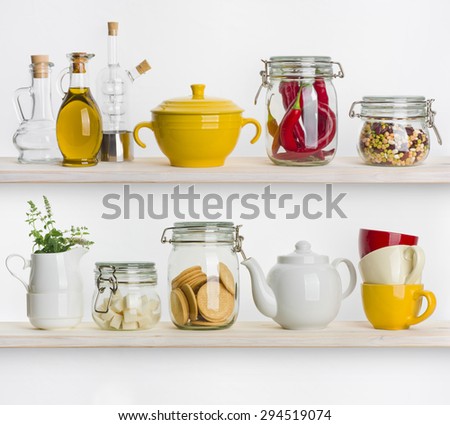 Kitchen shelves with various food ingredients and utensils on white