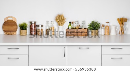 Kitchen bench shelf with various herbs, spices, utensils on white