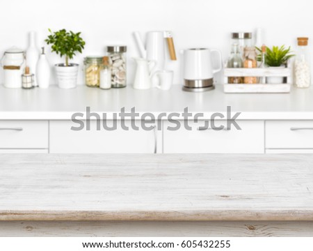 Wooden table with bokeh image of different kitchen common products