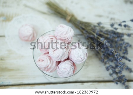 Strawberry zephyr on a light wooden table. Rustic background