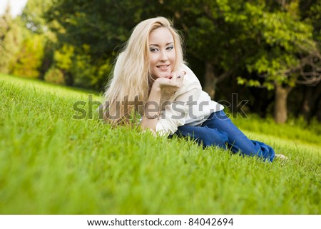 outside portrait of beautiful young blond woman on natural background