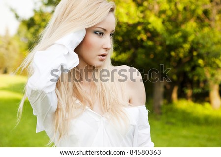 Portrait of naturally beautiful woman in her twenties with blond hair, shot outside in natural sunlight