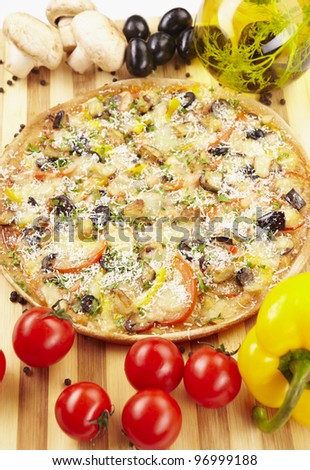 Pizza vegetarian with eggplant, olives, tomatoes, parmesan