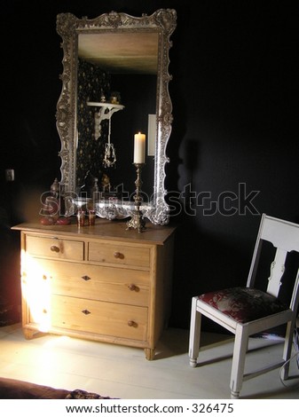 photograph of a mirror and chest of drawers in a beautiful classy black master bedroom
