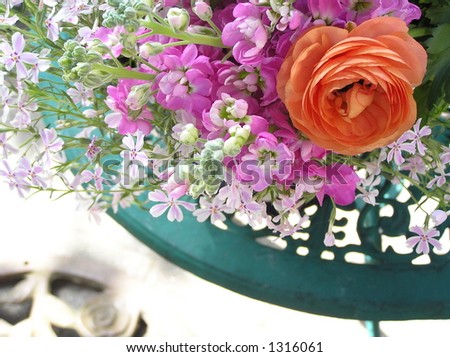artistic shot of a variety of flowers on a garden table,  expressing the feeling of summer
