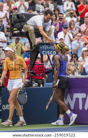 MONTREAL - AUGUST 8: Serena Williams of USA greets the referee after her quarter final match win over Caroline Wozniacki of Denmark at the 2014 Rogers Cup on August 8, 2014 in Montreal, Canada
