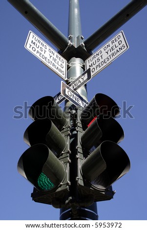 signs and stop light on street corner