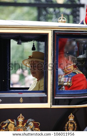 LONDON - JUNE 16: Queen Elizabeth II and Prince Philip seat on the Royal Coach at Queen\'s Birthday Parade on June 16, 2012 in London, UK. Queen\'s Birthday Parade take place in every June in London.