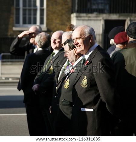 LONDON - NOV 13 : People take part in Remembrance Day, Poppy Day or Armistice Day, 11th every Nov, to remember armed forces who have died since First World War, Parade on Nov 13, 2011, London, UK.