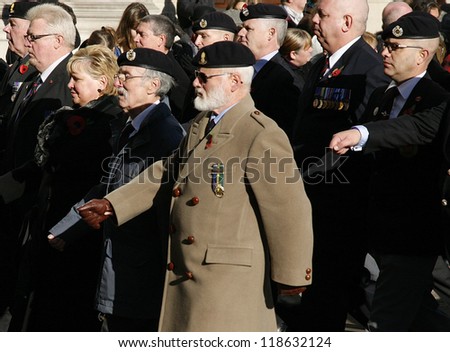 LONDON - NOV 11 : People take part in Remembrance Day, Poppy Day or Armistice Day, 11th every Nov, to remember armed forces who have died since First World War, Parade on Nov 11, 2012, London, UK.