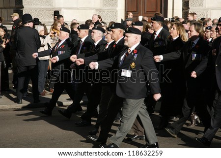 LONDON - NOV 11 : People take part in Remembrance Day, Poppy Day or Armistice Day, 11th every Nov, to remember armed forces who have died since First World War, Parade on Nov 11, 2012, London, UK.