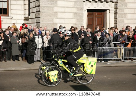 LONDON - NOV 11 : St John Ambulance aiders, bicycles allow to move more quickly through crowds with medical equipment, are ready to help patients at Remembrance Day, on November 11, 2012, London, UK