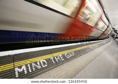 Inside view of London Underground Tube Station with Moving train, motion blurred.
