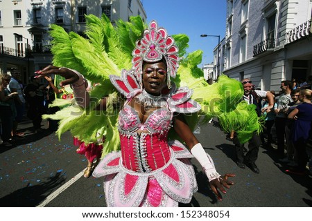 LONDON - AUG 26: Participant with carnival costume in the second day of Notting Hill Carnival, largest in Europe, on August 26, 2013 in London, UK. Carnival takes place over two days in every August
