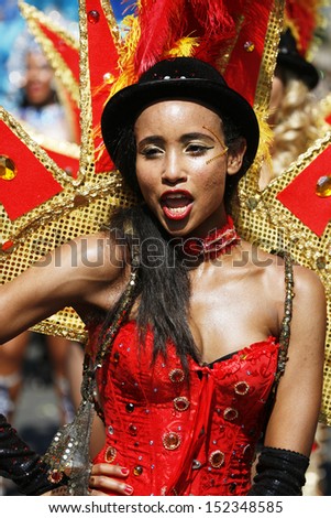 LONDON - AUG 26: Participant with carnival costume in the second day of Notting Hill Carnival, largest in Europe, on August 26, 2013 in London, UK. Carnival takes place over two days in every August