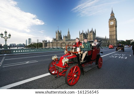 LONDON - NOV 03: London to Brighton Veteran Car Run participants passing Westminster Bridge, Big Ben in the background, on November 03, 2013 in London, UK. Event starts at 7:00am in Hyde Park, London