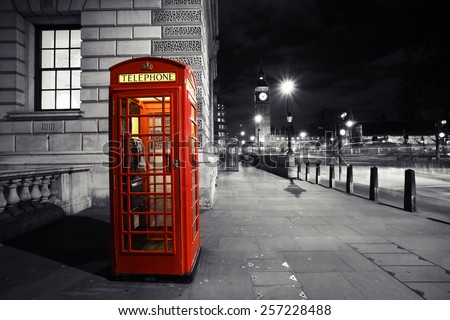 Red phone booth, in Parliament Square, one of the most famous icons of London, Big Ben is in the far behind.