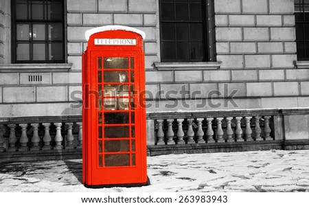 London Red Telephone Booth at dawn on a snow day, winter, London.