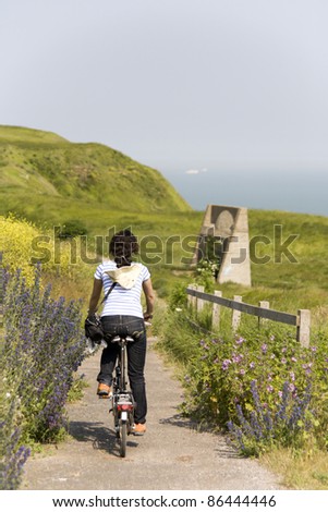 Woman in holidays cycling around Dover, UK