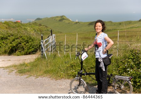 Woman in holidays cycling around Dover, UK
