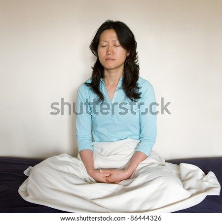 One East Asian woman seat in meditation