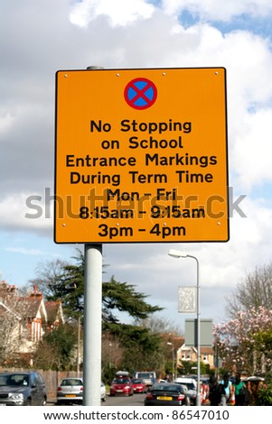 Street post with no stopping on school entrance