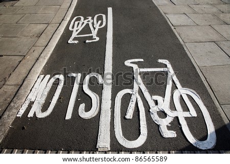 Bicycle lane with white mark of bicycle sign, London.
