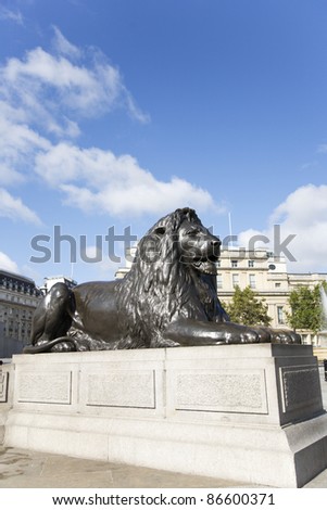 The four lion statues surrounding Nelson\'s column in Trafalgar Square are one of the most famous places for tourists.